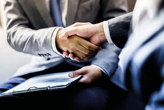 businessman shaking hands to seal a deal with his partner