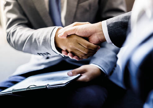 businessman shaking hands to seal a deal with his partner